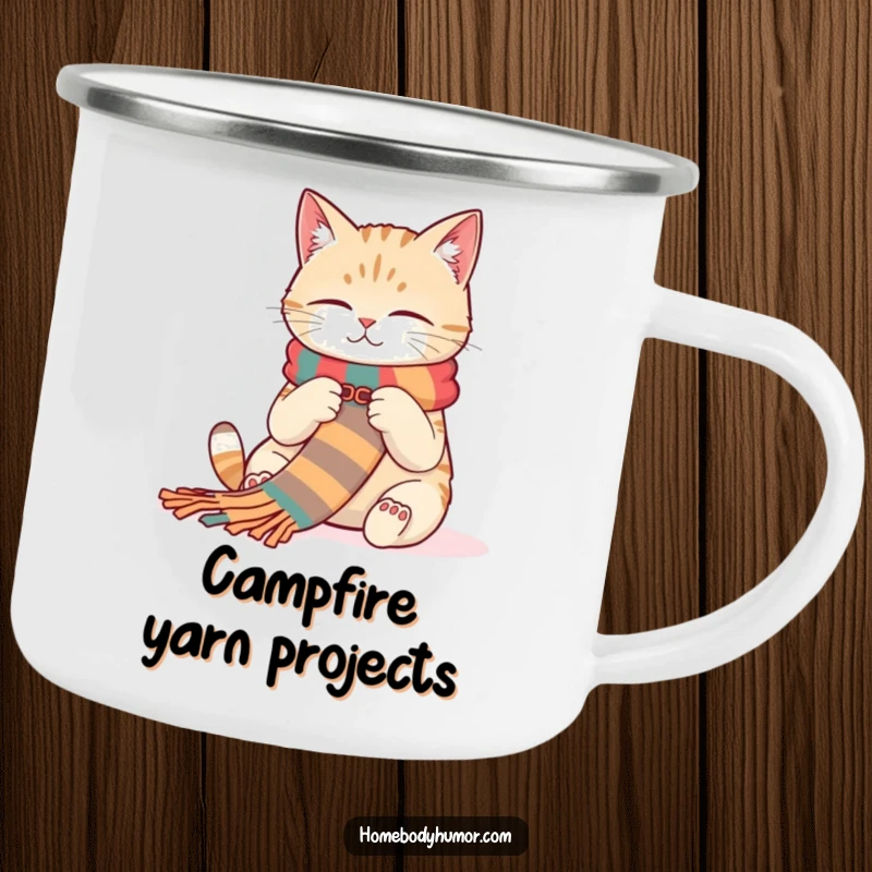 Funny Cat Campfire Mug: A contented cat knitting a scarf, perfect for enjoying drinks outdoors with humorous charm. A wonderful funny gift.